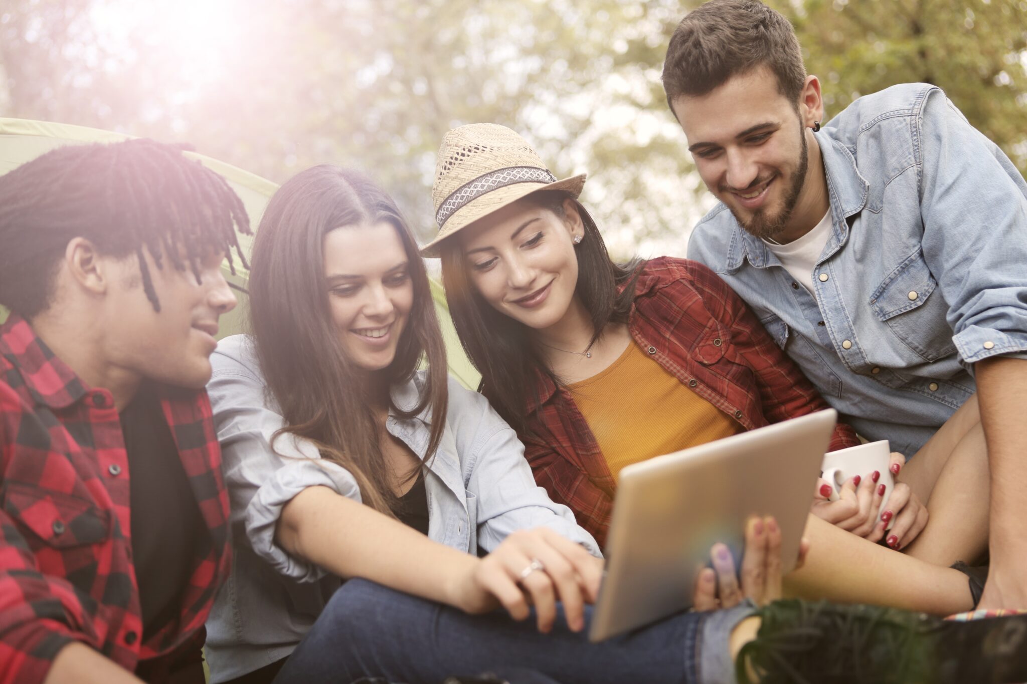 Four teens looking at a tablet